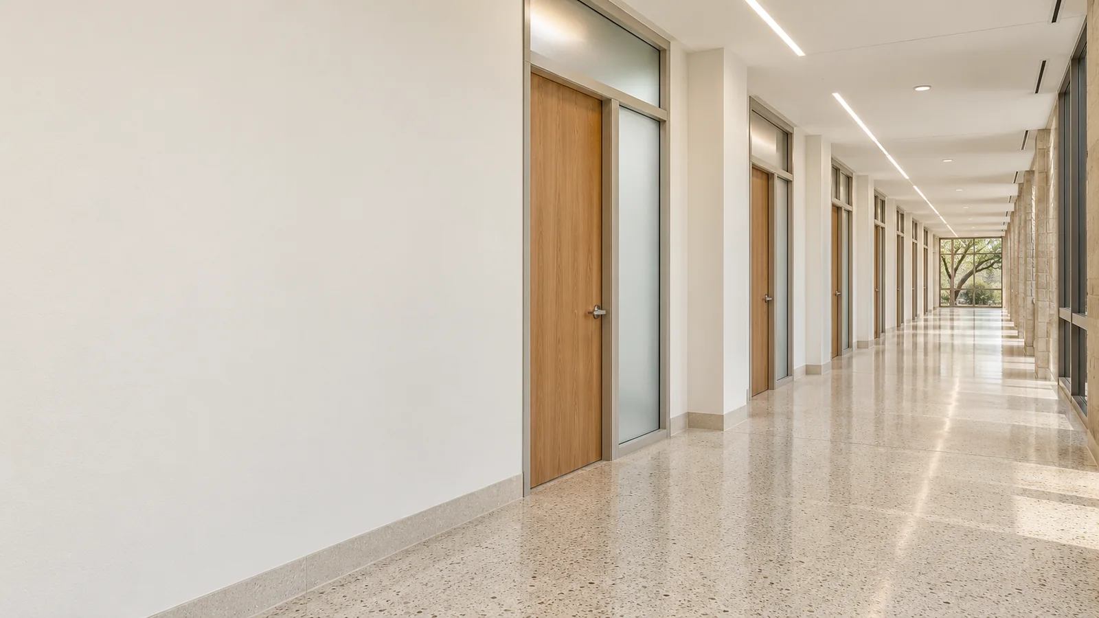 Renovated institutional facility corridor with new flooring and LED lighting